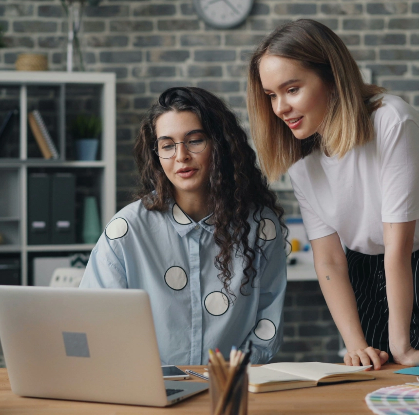 Two women looking at a laptop screen